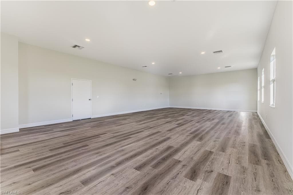 Spare room featuring light wood-type flooring and recessed lighting