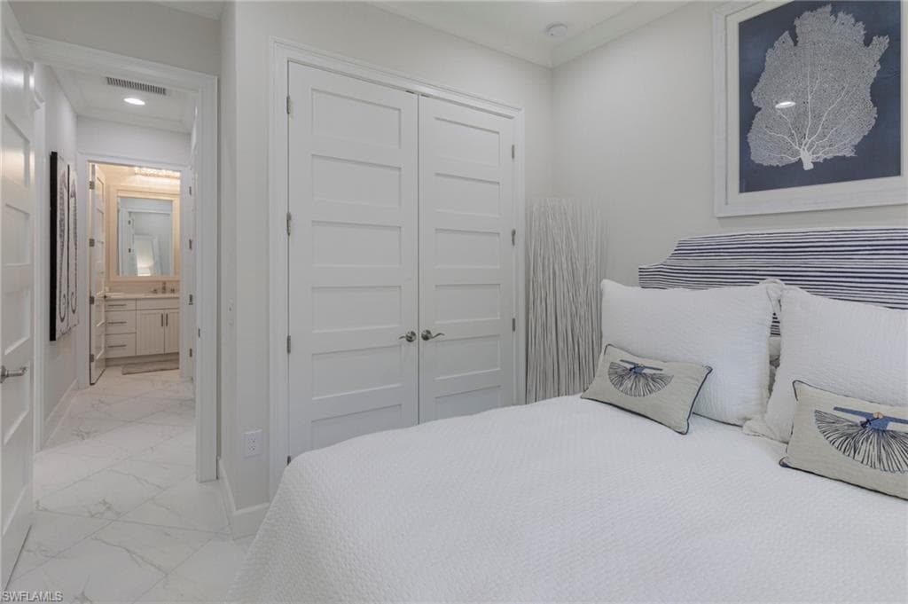 Bedroom featuring ensuite bathroom and a closet