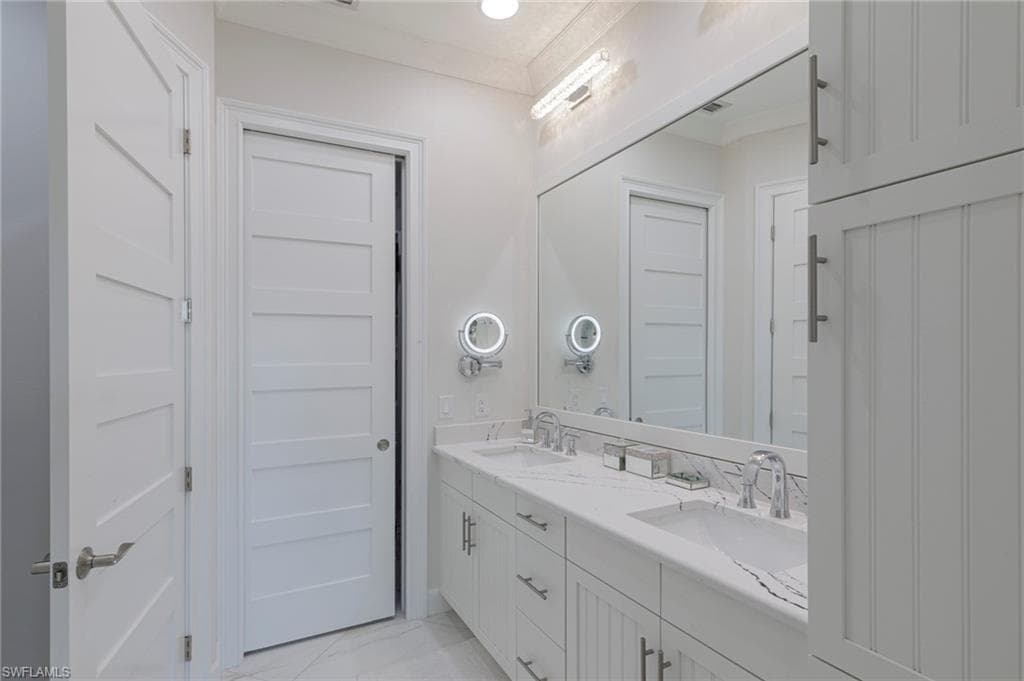 Bathroom featuring crown molding and vanity
