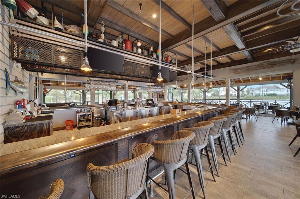 Dining area featuring vaulted ceiling with beams, a water view, and wood ceiling