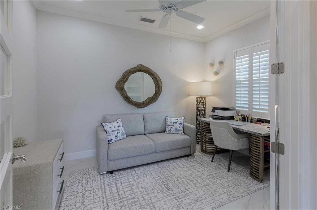Office space with ceiling fan and crown molding