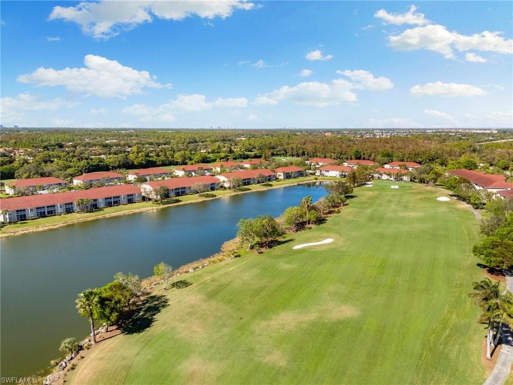 Birds eye view of property with a water view