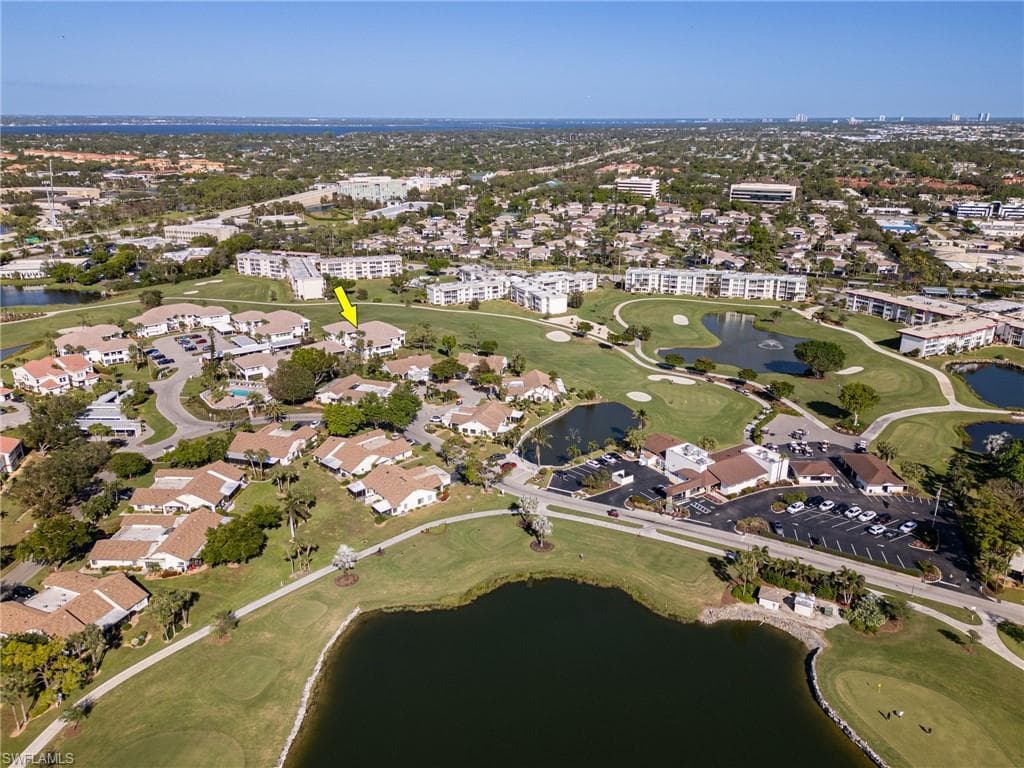 Birds eye view of property with a water view
