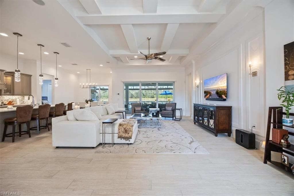 Coastal toned porcelain flooring throughout the home and decorative wall molding in the living room