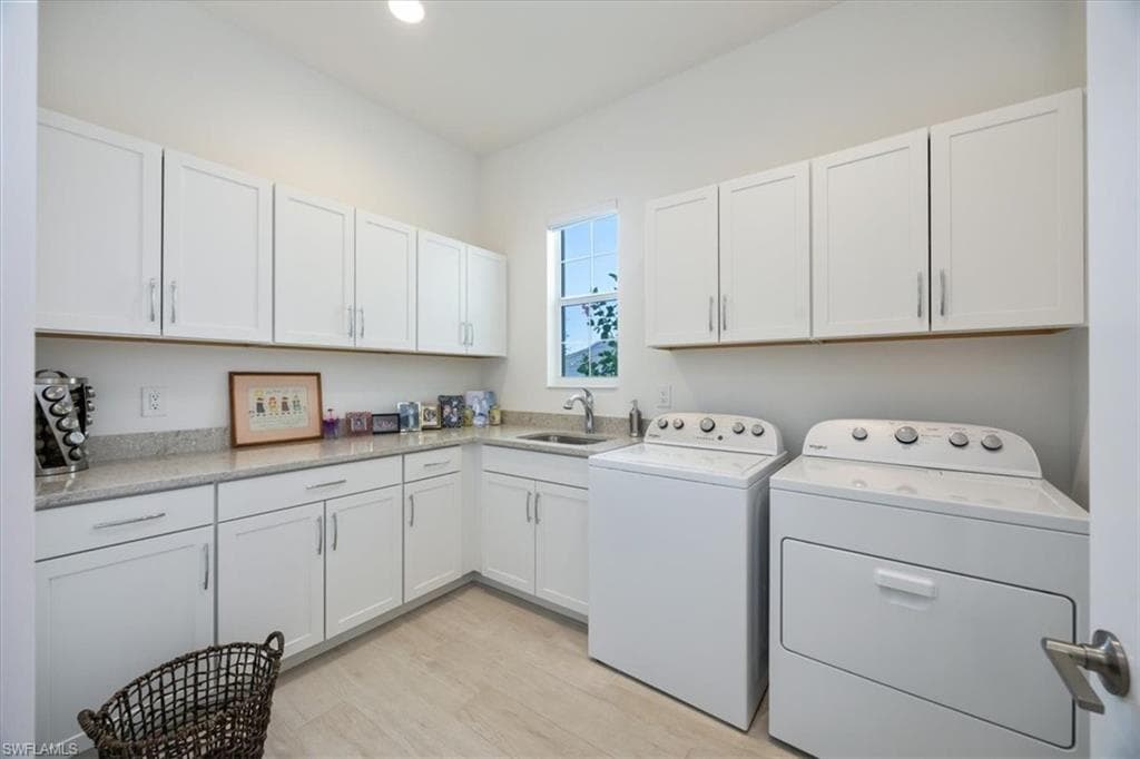 Enourmous laundry room with a utility sink and an abundance of storage