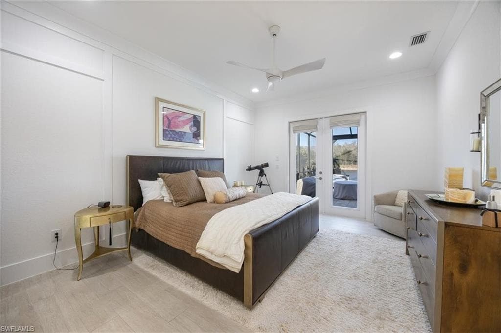 The very spacious primary bedroom has French doors that open to the pool deck