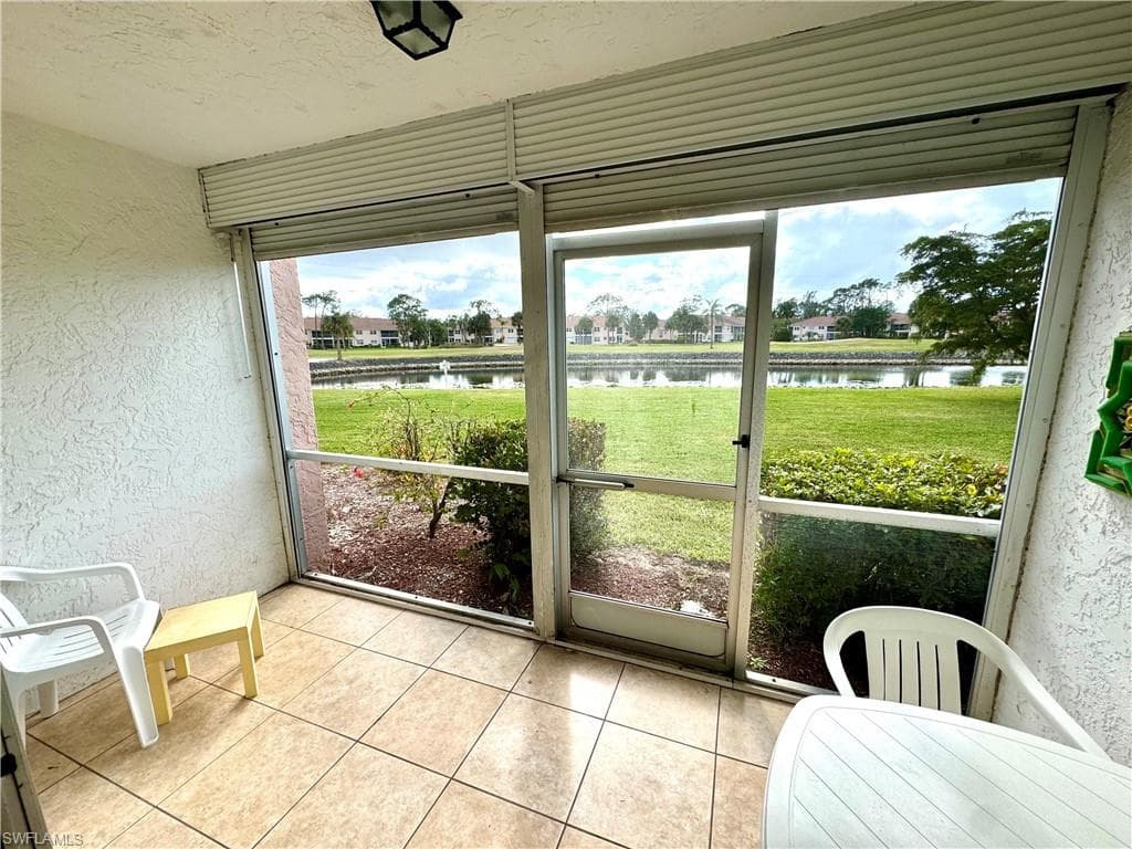 Sunroom / screened lanai featuring a water view