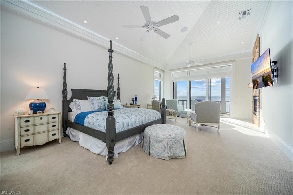 Bedroom with crown molding, high vaulted ceiling, wood ceiling, and ceiling fan.