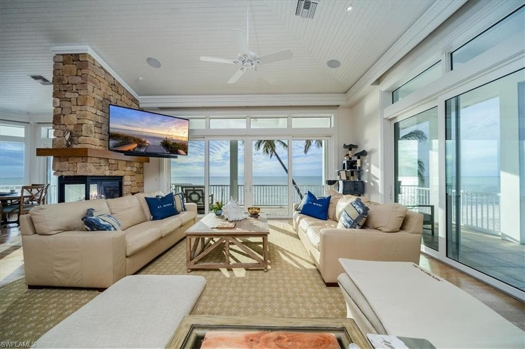 Living Room featuring wood ceiling, ceiling fan, and a fireplace