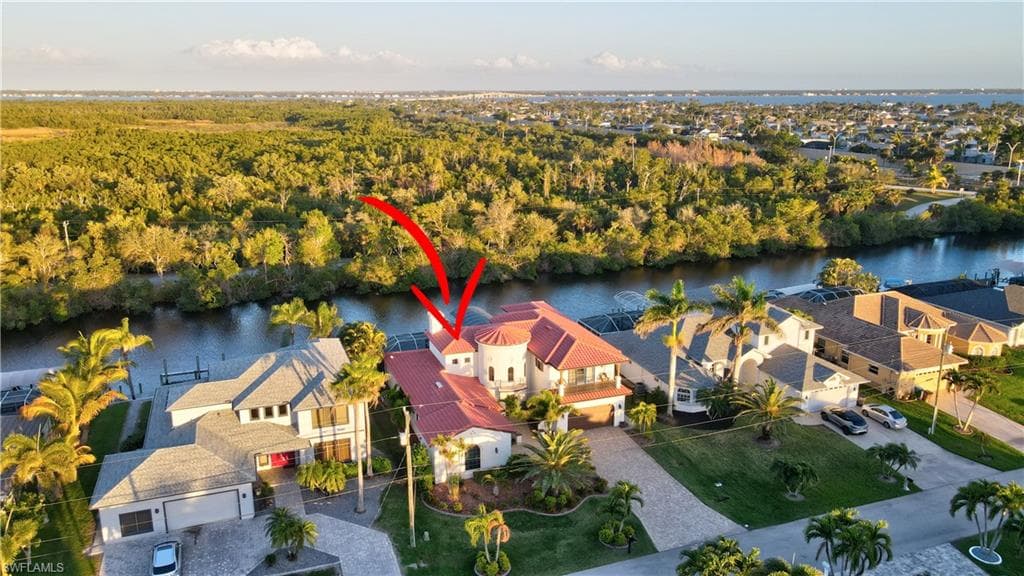 Birds eye view of property with a water view