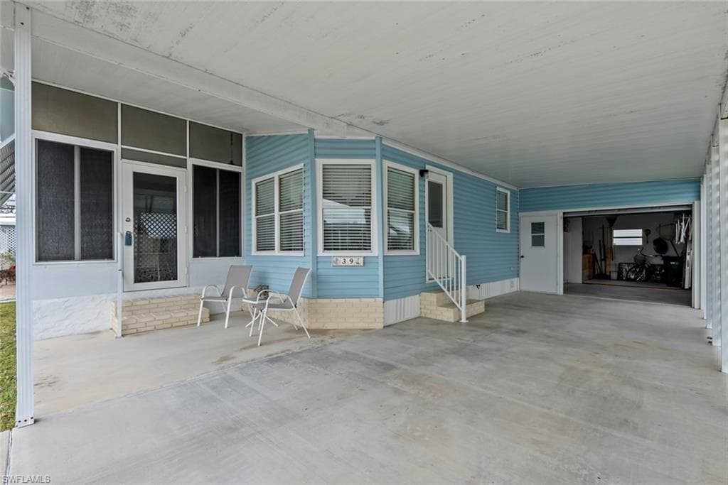View of patio with a carport