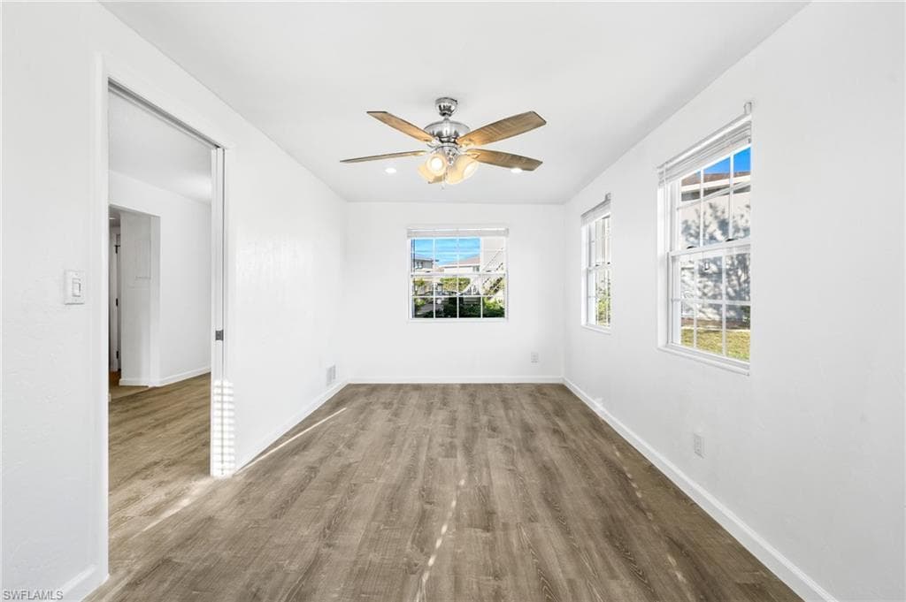 Empty room featuring ceiling fan and LVP wood-style floors, Extra Square footage