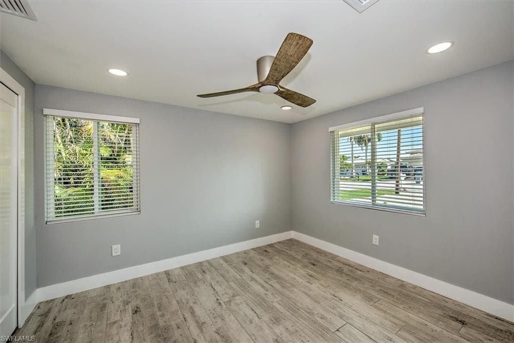 Empty room featuring ceiling fan and light hardwood / wood-style flooring