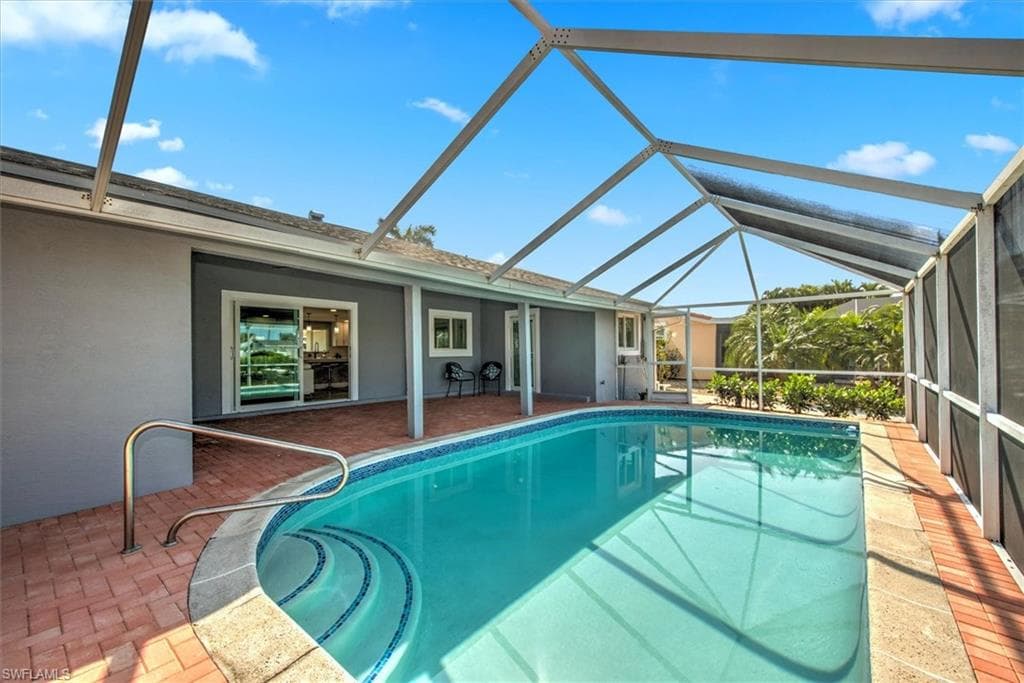 View of swimming pool with a lanai and a patio area