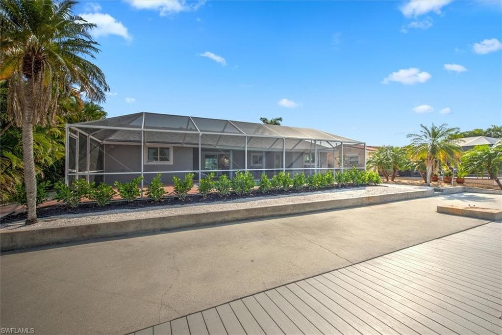 Rear view of house featuring a lanai