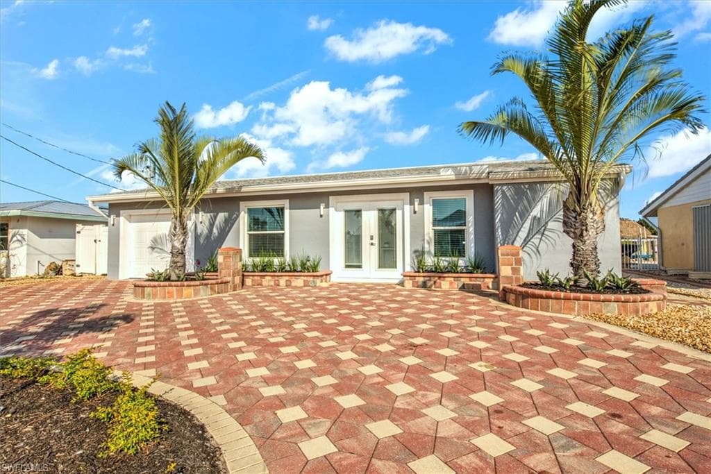 View of front of property featuring french doors and a garage