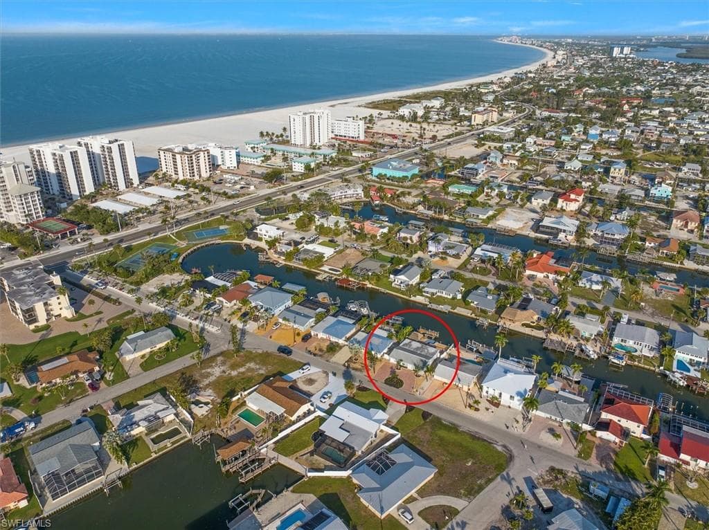 Aerial view featuring a beach view and a water view