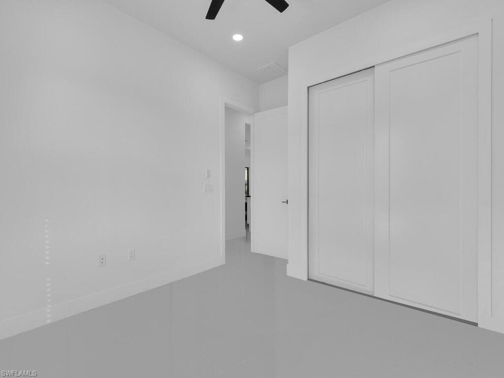 Unfurnished bedroom featuring ceiling fan and a closet