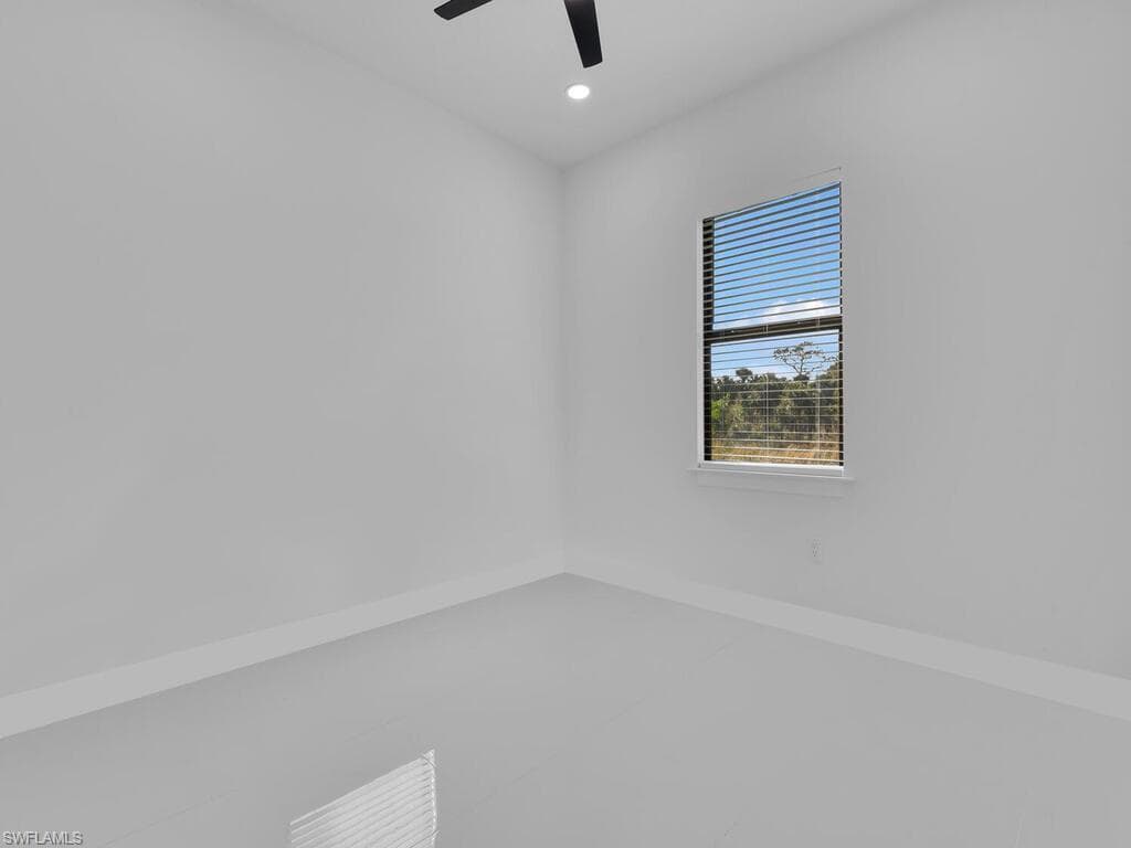 Spare room with ceiling fan