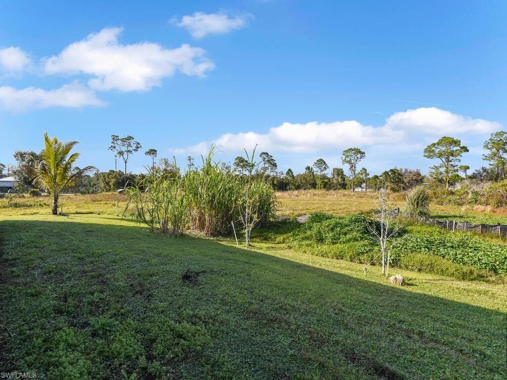 View of yard with a rural view