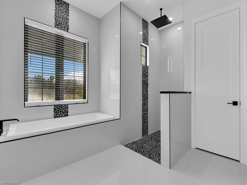 Bathroom featuring shower with separate bathtub