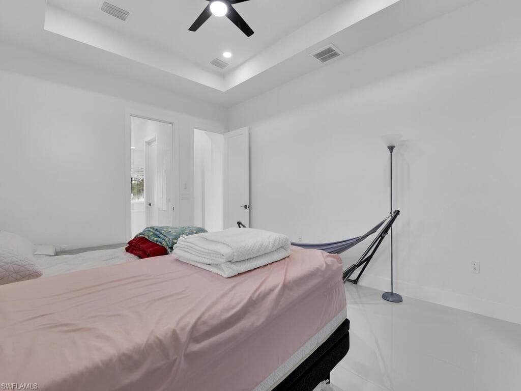 Bedroom featuring ceiling fan and a raised ceiling