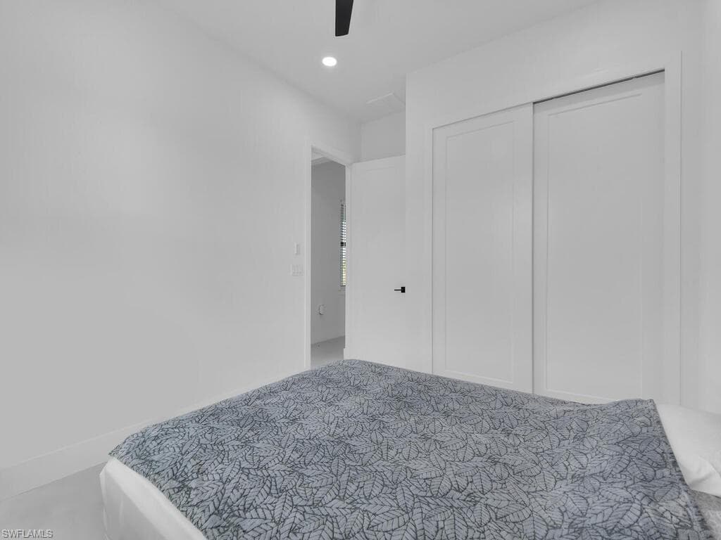 Bedroom featuring ceiling fan and a closet