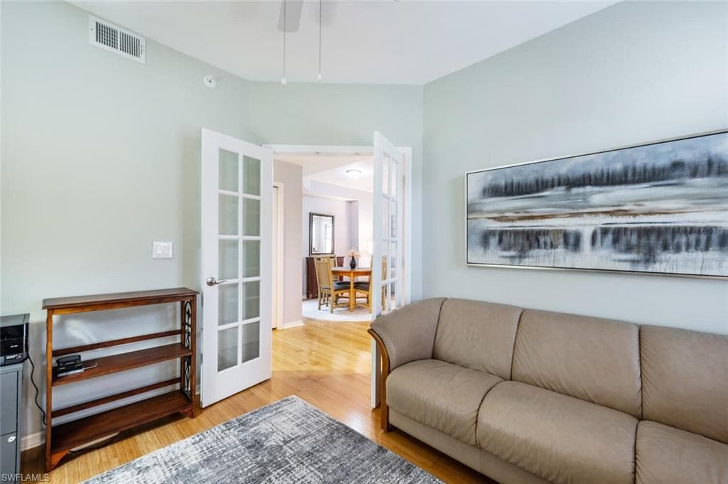 Living room featuring light wood-type flooring and french doors