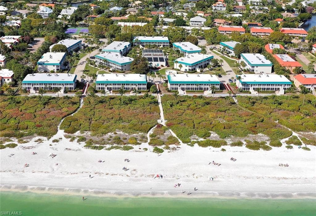 Birds eye view of property with a water view