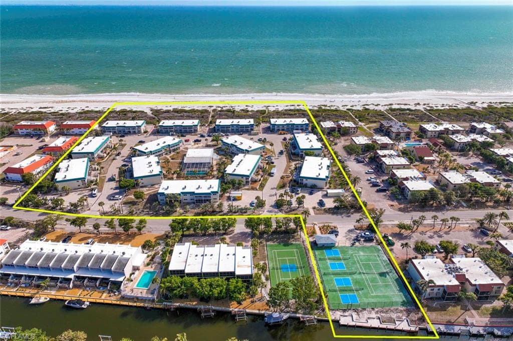Drone / aerial view with a view of the beach and a water view