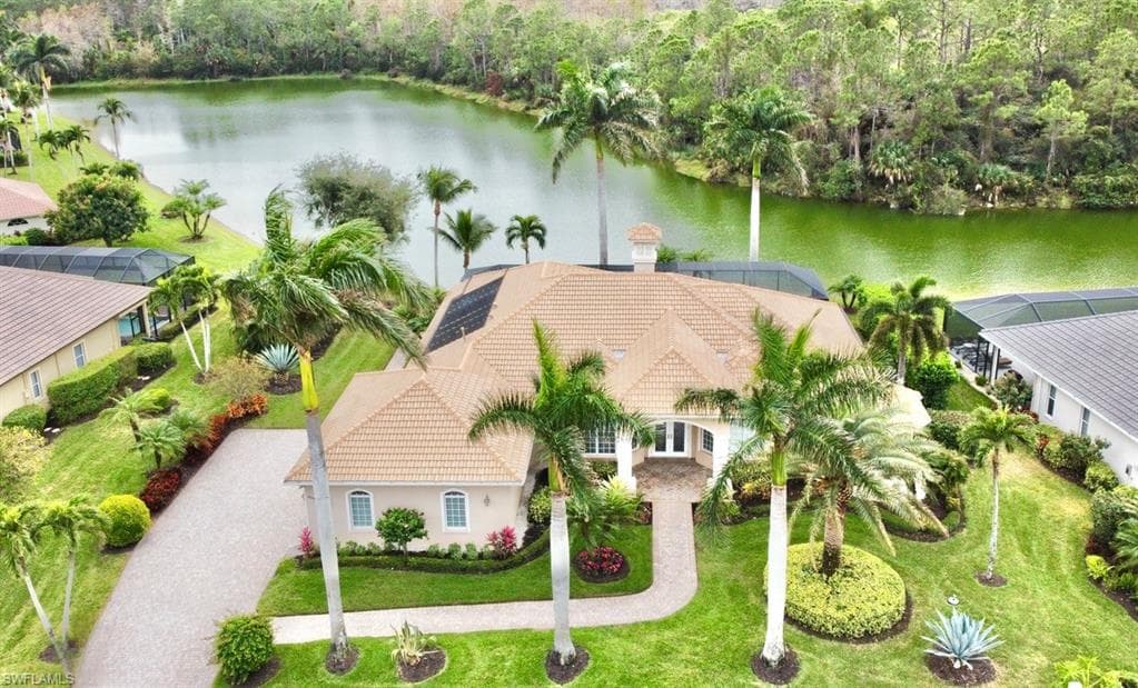 Birds eye view of property featuring a water view