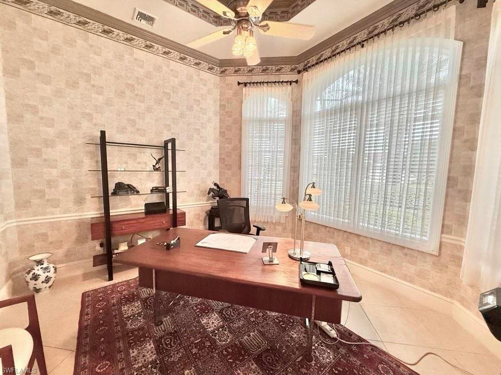 Office area with tile patterned flooring, ornamental molding, and ceiling fan