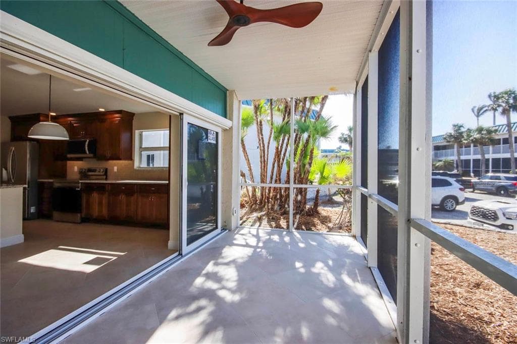 Sunroom / solarium featuring ceiling fan