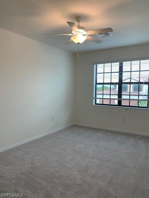 2nd Carpeted spare room with ceiling fan
