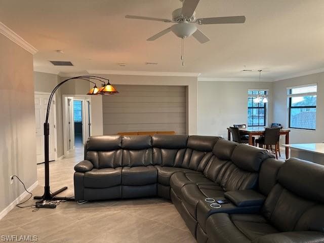 Tiled living room with ornamental molding and ceiling fan. Far wall has ship lap.