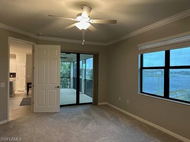 Master bedroom unfurnished room with light carpet, ornamental molding, and ceiling fan