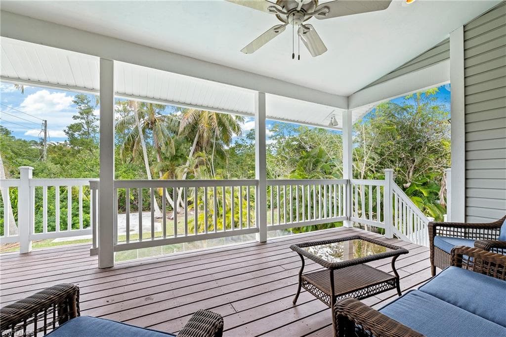 Sunroom / solarium featuring vaulted ceiling, a wealth of natural light, and ceiling fan