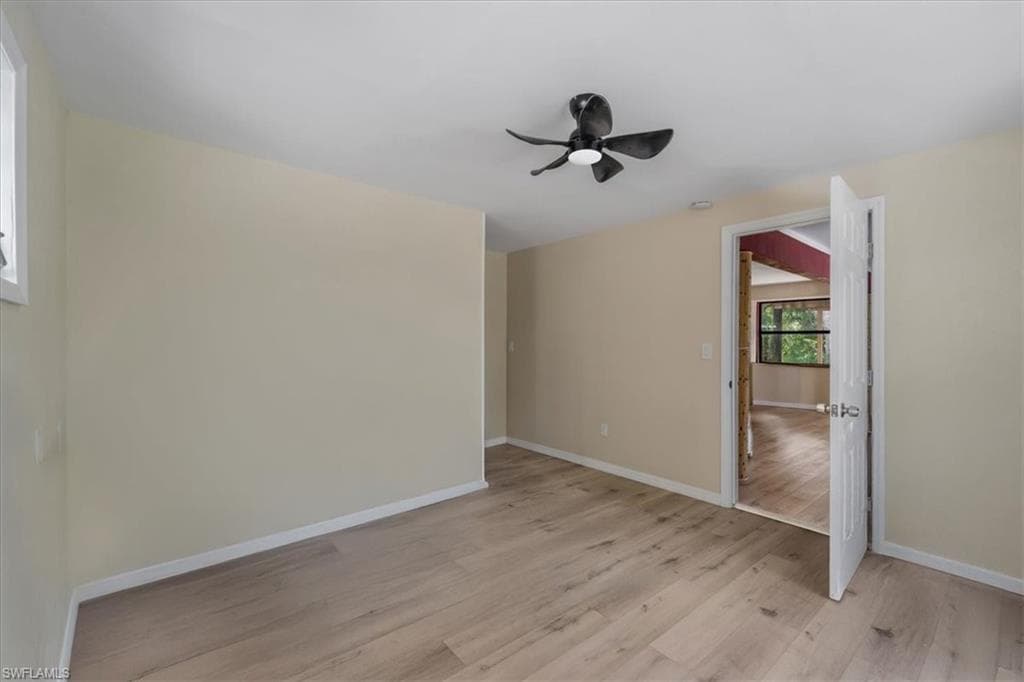 Spare room featuring ceiling fan and light hardwood / wood-style floors