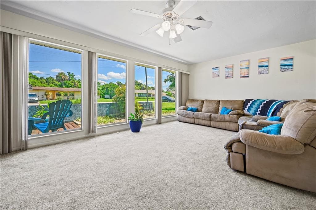 Living room with ceiling fan and carpet flooring