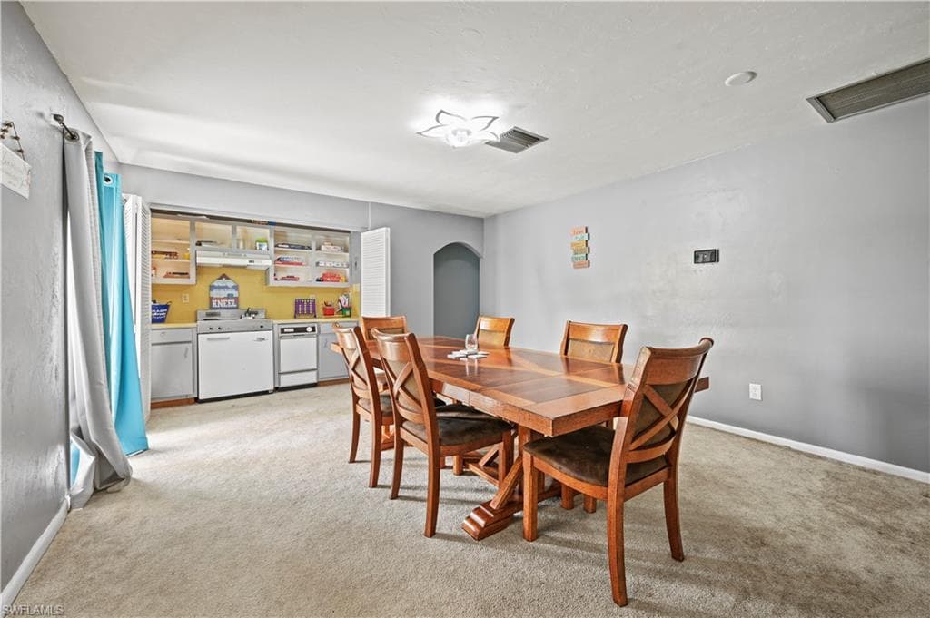 Dining area with light colored carpet