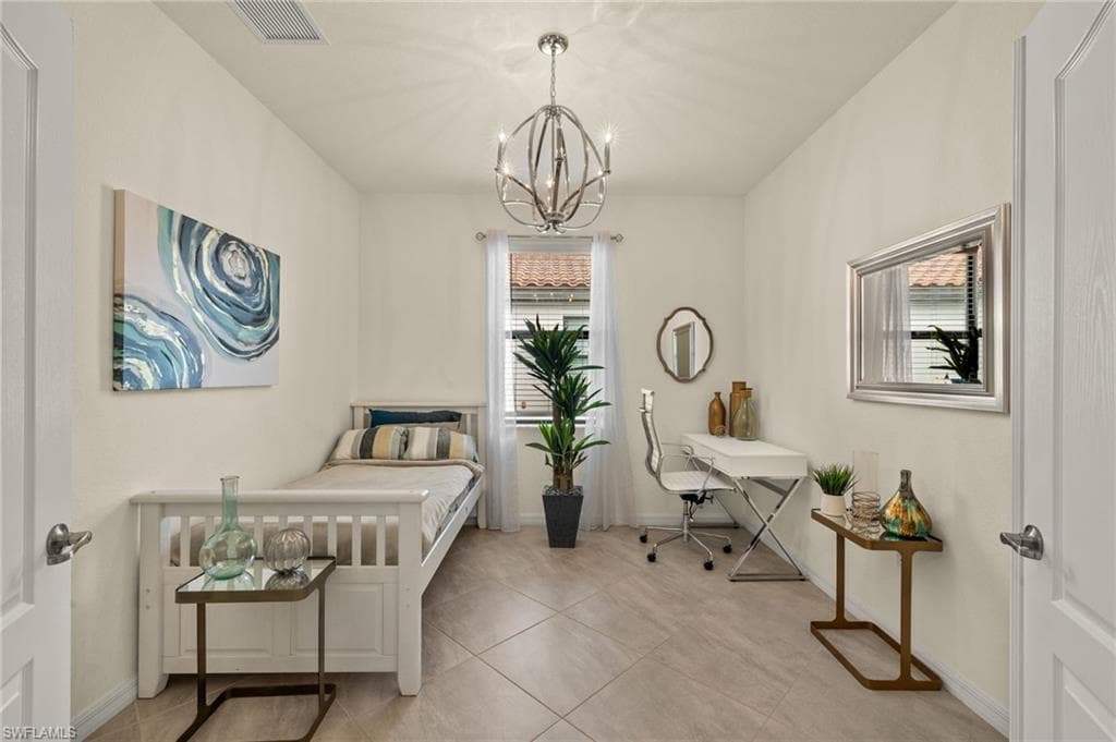 Tiled bedroom featuring an inviting chandelier