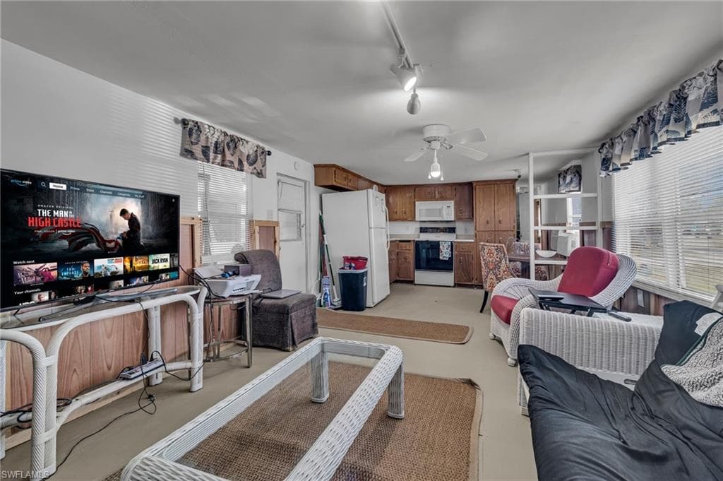 Living room featuring a ceiling fan and track lighting