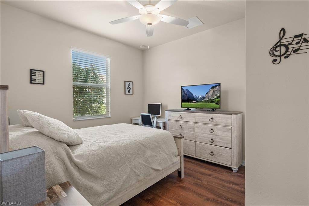 Bedroom 4 with luxury vinyl wood-style floors and a ceiling fan