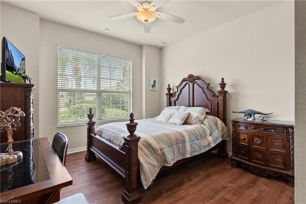 Bedroom 3 with large window, a ceiling fan, and luxury vinyl finished floors