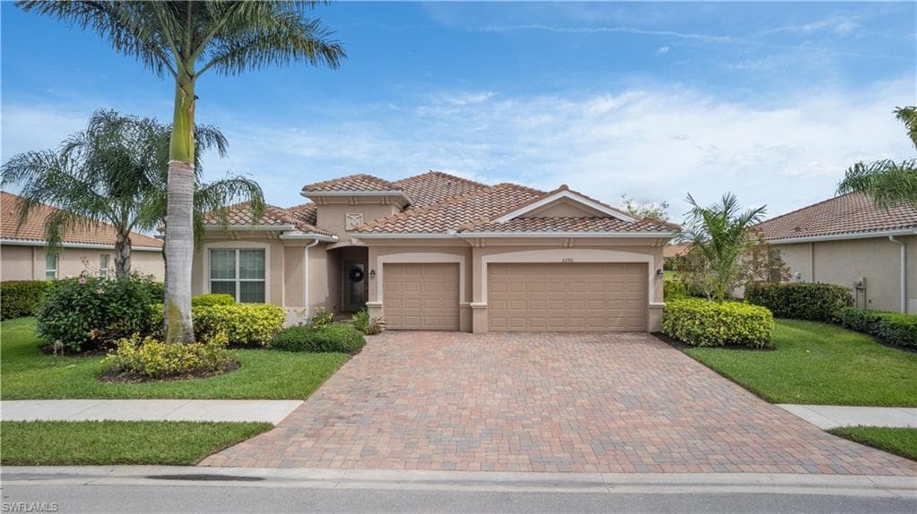 Lennar Summerville II floor plan - featuring double front door, a spacious 3 car garage, 3 car paver driveway, a tile roof, and concrete stucco siding