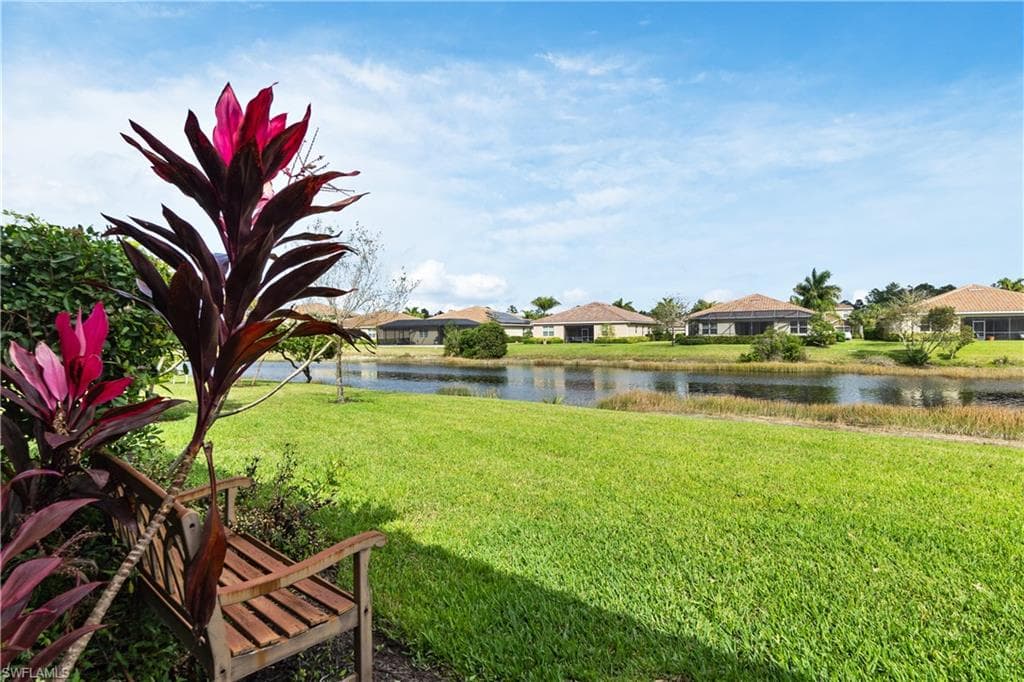 View of yard featuring a residential view and a water view