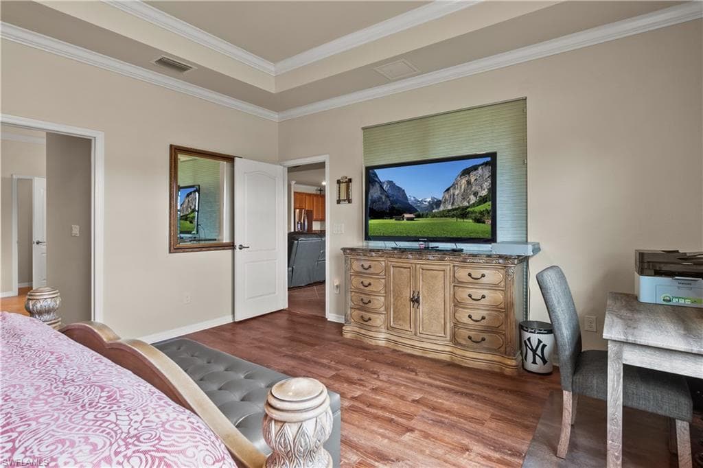Second view of Master bedroom with crown molding, baseboards, and luxury vinyl finished floors