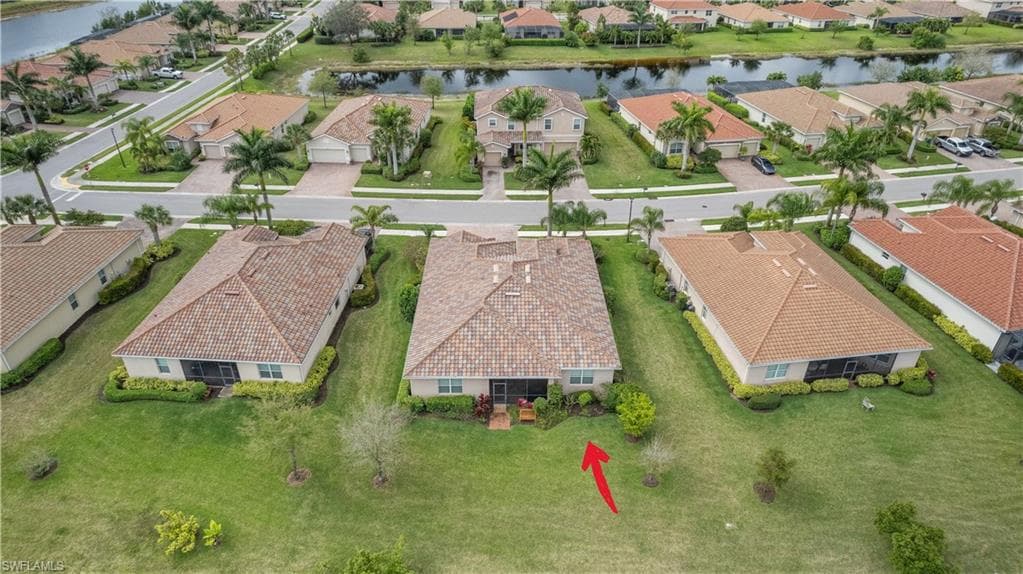 Bird's eye view with a water view and a residential view