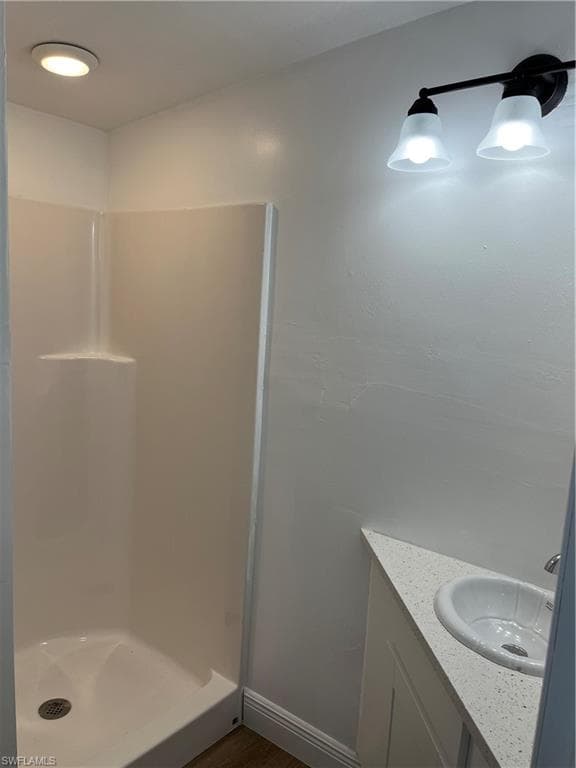 Bathroom with vanity and a stall shower