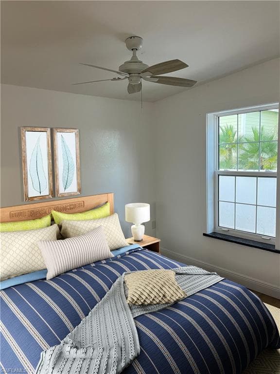 Bedroom with baseboards and ceiling fan